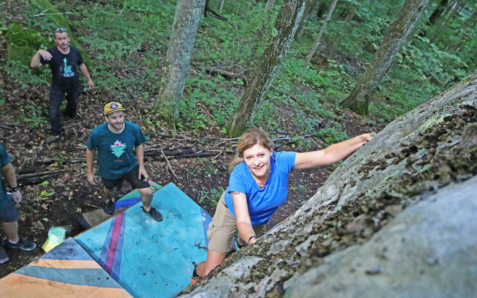 Two people participating in a bouldering clinic held at High Knob Outdoor Fest in Norton