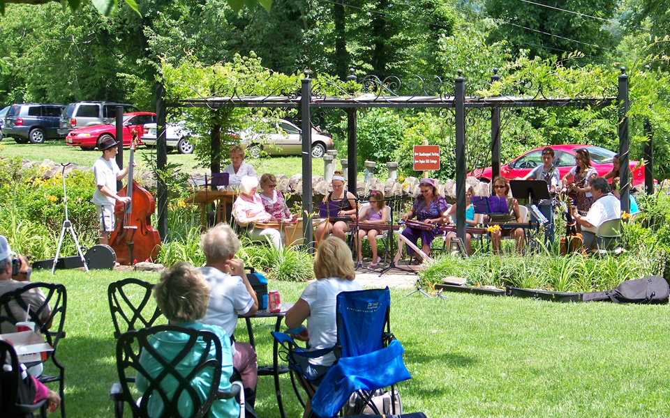 Musicians performing outside the Southwest Virginia Historical Museum during the Lunch on the Lawn Music Series as audiences watch from the lawn