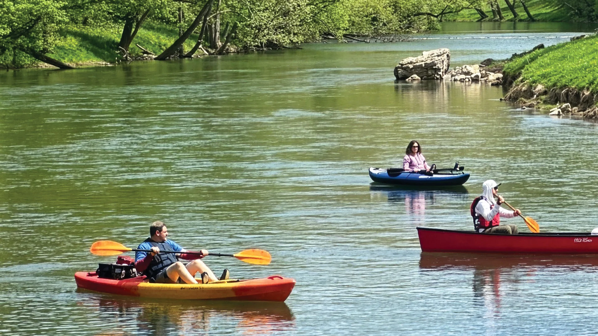 Kayakers and canoeists paddling the Clinch River in Southwest Virginia on a sunny spring day
