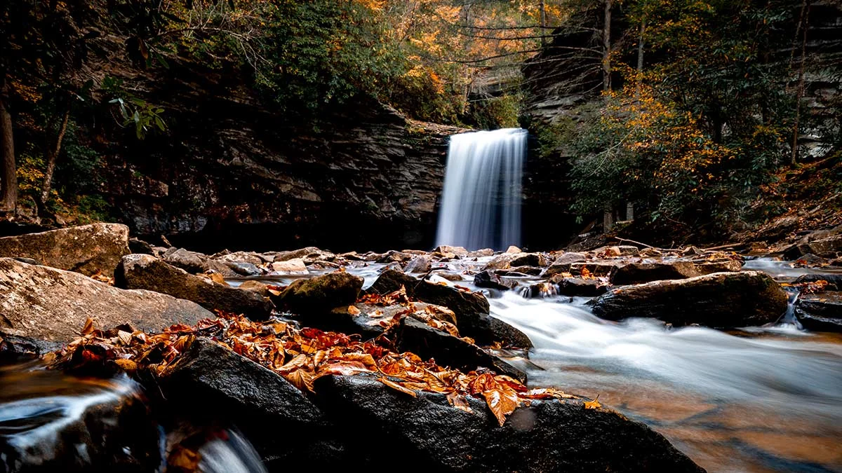 Little Stony Falls plunging into a rocky creek framed by autumn foliage in Scott County, Virginia