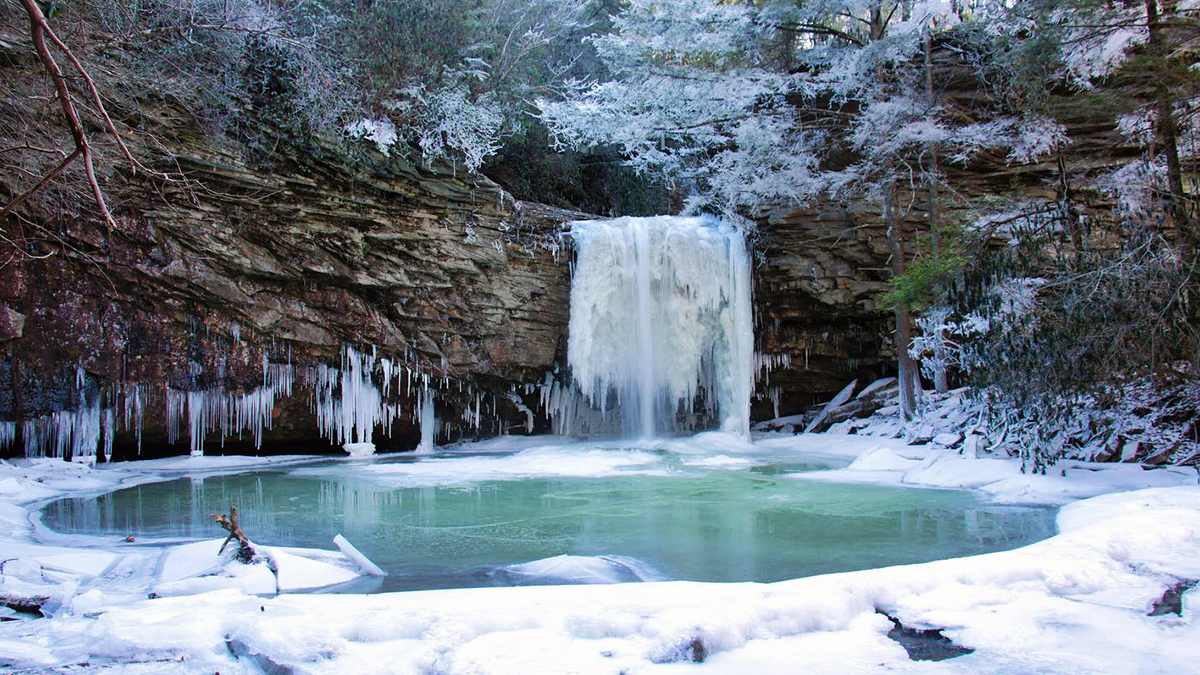 Little Stony Creek Falls framed by ice and snow in winter in Scott County, Virginia