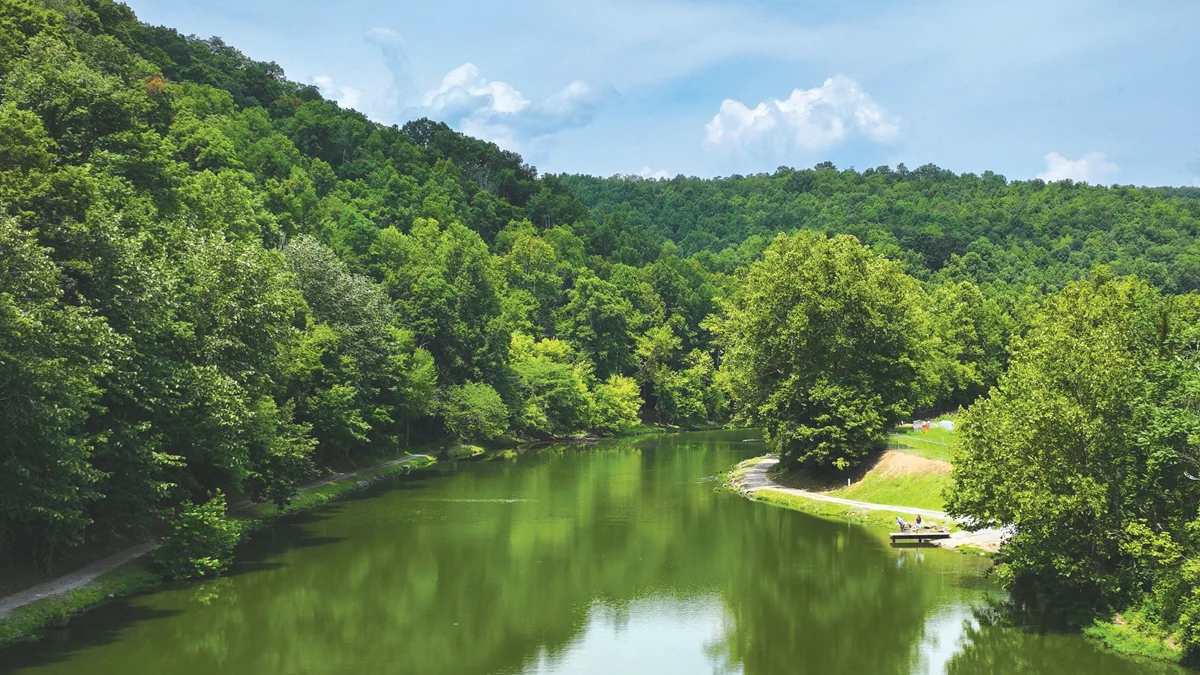 Calm green waters of the Clinch River winding through forested hills to a river access in Southwest Virginia