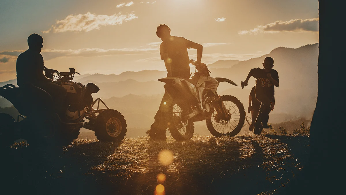 atv-dirt-bike-riders-sunset-mountains-virginia.jpg Silhouette of off-road riders with an ATV and dirt bike at sunset, looking out over a mountain ridge in Virginia.