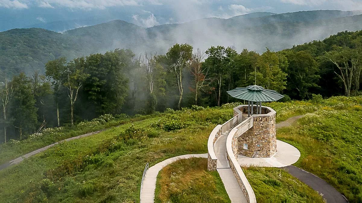 Stone observation tower with a winding path on a misty mountaintop at High Knob in Wise County