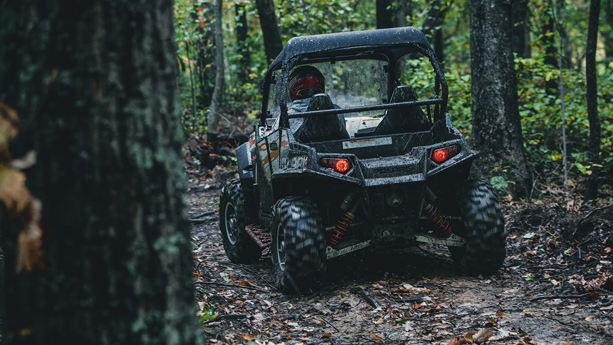 muddy-utv-forest-adventure-pocahontas-trail-spearhead-trails.jpg A mud-covered side-by-side drives along a wet forest trail after recent rain in Southwest Virginia.