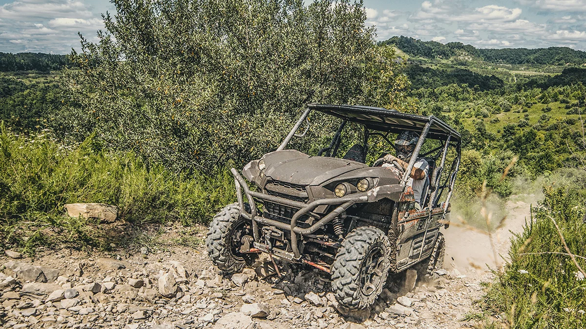 muddy-utv-rock-crawling-coal-canyon-trail-spearhead-trails-virginia.jpg A muddy side-by-side vehicle climbing a steep, rocky trail in the open terrain of the Coal Canyon Trail System in Virginia.