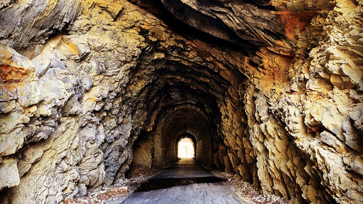 The stone and brick portal of the Powell River Tunnel, a former rail tunnel now a walking and biking path in Appalachia, Wise County.