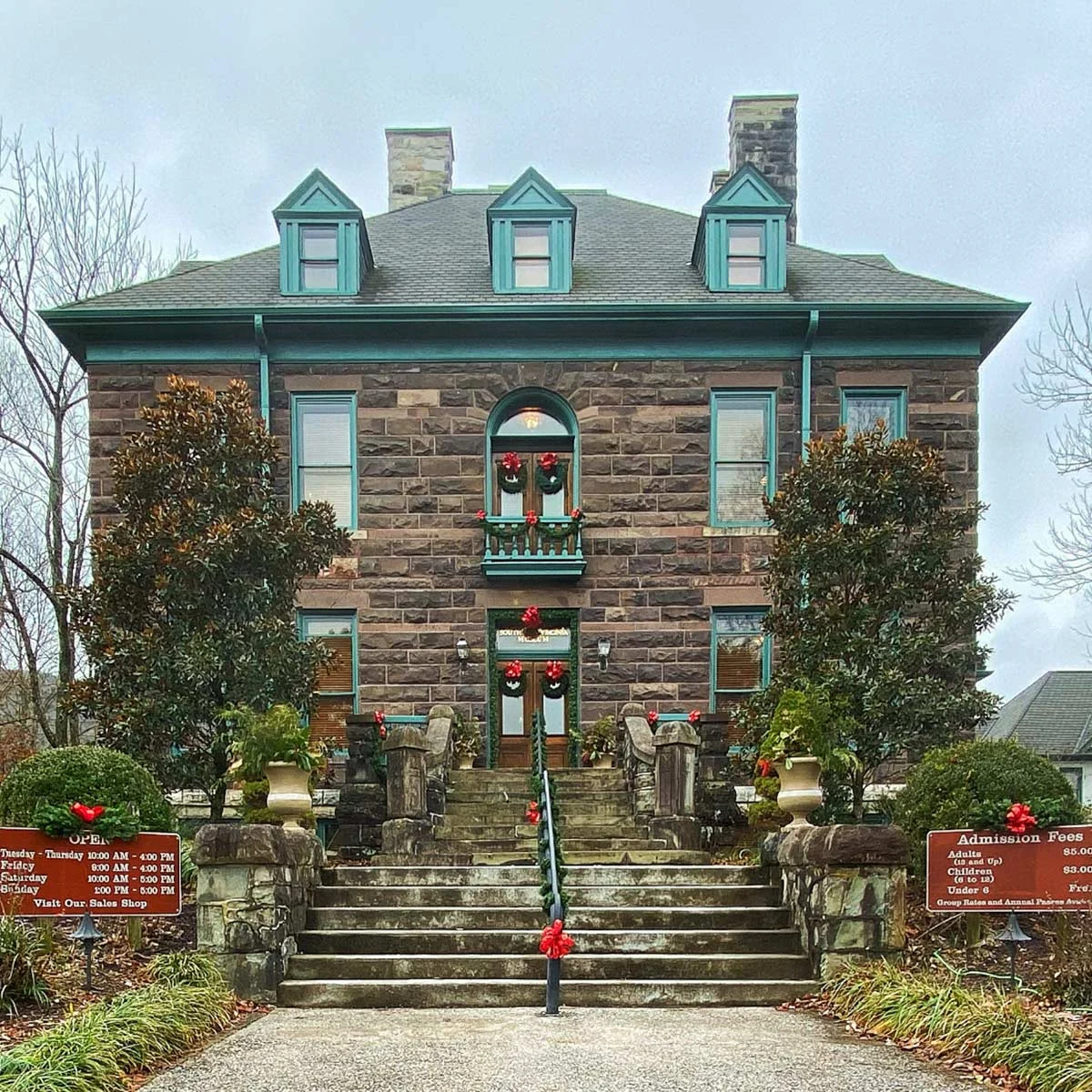 The 1890s stone mansion at Southwest Virginia Museum Historical State Park with holiday wreaths in winter, Big Stone Gap.