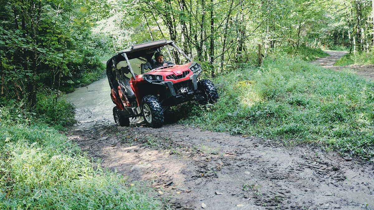 utv-creek-crossing-ridgeview-trail-spearhead-trails-virginia.jpg A red side-by-side exits a shallow creek crossing on a forest trail in SW Virginia's Ridgeview Trail.