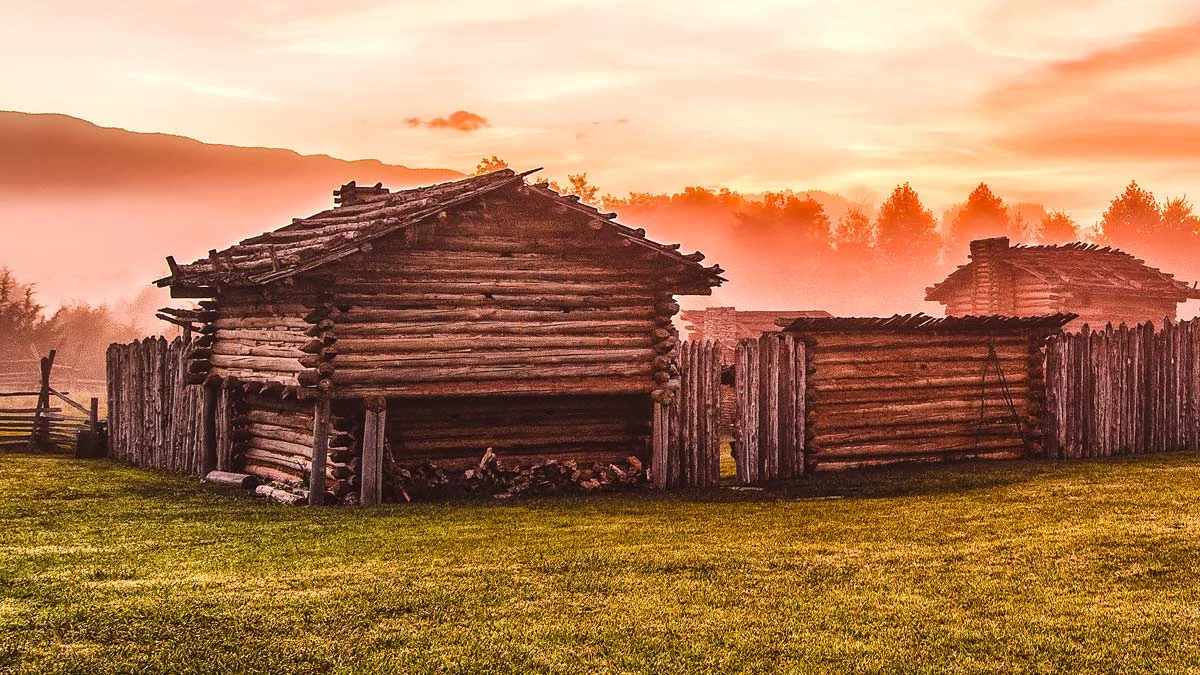 Reconstructed log fort and stockade at Wilderness Road State Park glowing at sunset