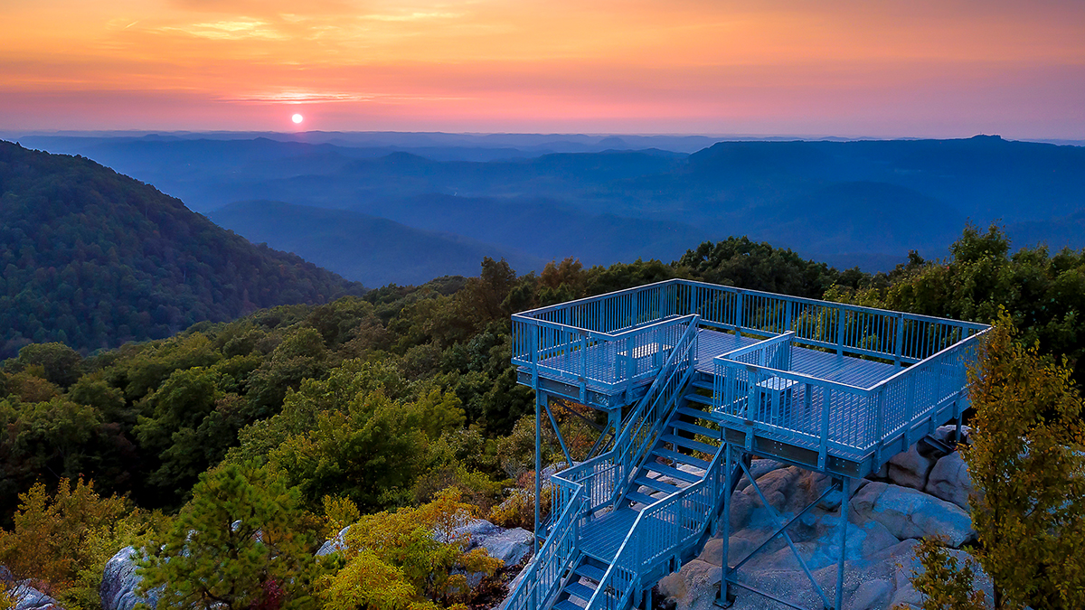 Sunset over layered blue ridges from the steel observation deck atop Birch Knob Tower in Dickenson County, Virginia
